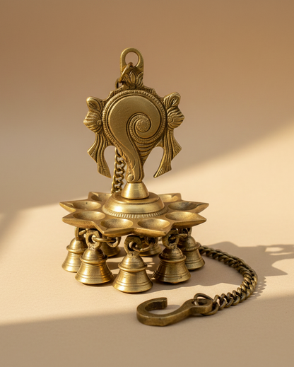 Handcrafted brass Shankh Chakra hanging diya with traditional bells